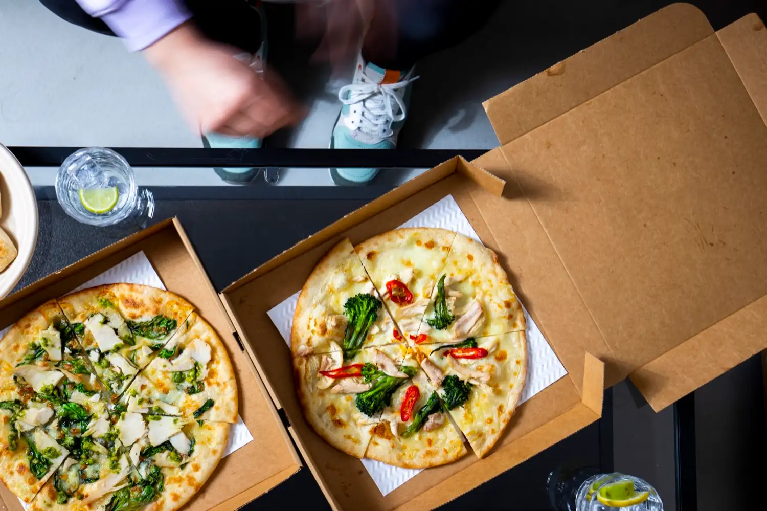 Two Protein Pizza Co. boxes open on a table, seen from above