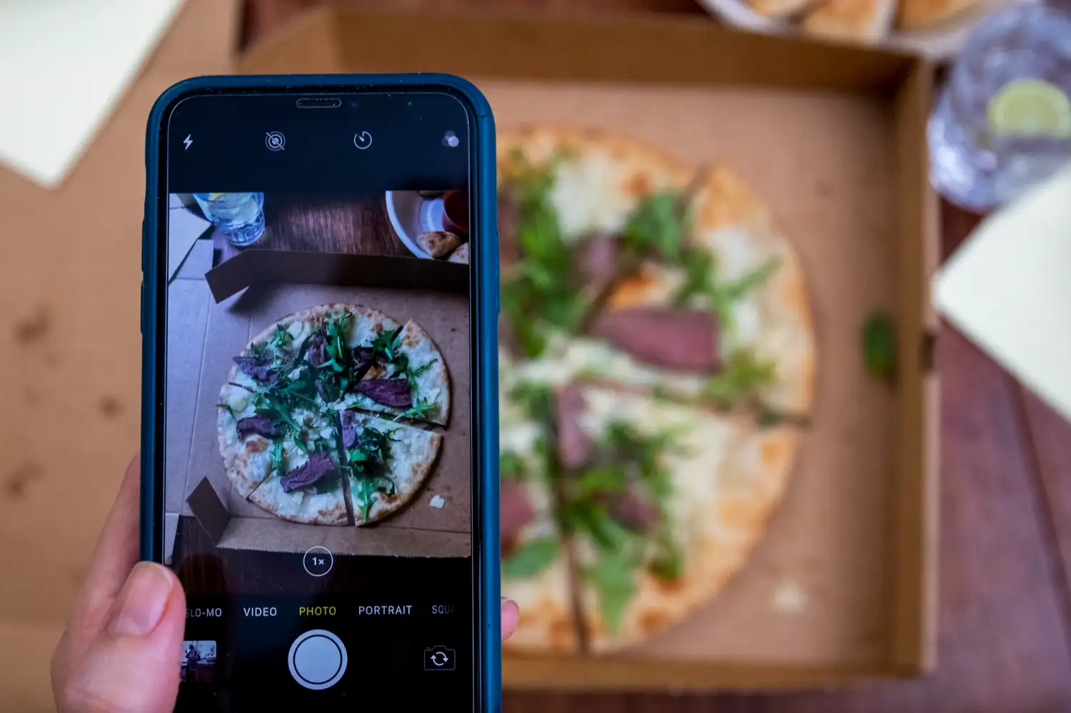 Someone photographing a Protein Pizza Co. pizza on their phone